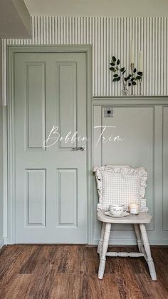 a chair sitting in front of a green door with the word blac tum on it