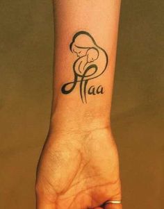 a woman's wrist tattoo with the word faa in black ink on it