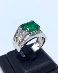 BRAND-NEW!! ONE OF A KIND, HANDCRAFTED RING. EXQUISITE AND FINE CRAFTSMANSHIP! HANDMADE TO LAST FOR AN ETERNITY!! HEIRLOOM PIECE!! PRECIOUS JEWELRY TO BE PASSED ON! PERFECT DRESS RING FOR A GENTLEMAN! 7.02 total carat weight, Certified, Natural emerald ring. This ring offers an important statement of who you are with a 4.76 carats, VIVID GREEN, transparent, ZAMBIAN EMERALD. Accentuating the EMERALD are the 48 SUBSTANTIAL F/VS, sparkling natural diamonds! Set in one of a kind, handmade 18K Solid Luxury Hallmarked Emerald Signet Ring, Luxury Green Signet Ring For Formal Occasions, Formal White Gold Emerald Signet Ring, Luxury Hallmarked Emerald Cut Signet Ring, Wide Band Gemstone Rings For Formal Occasions, Formal Wide Band Gemstone Ring, Luxury Baguette Cut Signet Ring For Formal Occasions, Luxury Wide Band Signet Ring For Formal Occasions, Formal White Gold Gia Certified Signet Ring