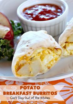 two burritos on a plate with salsa and an apple in the background that says potato breakfast burritos can't stay out of the kitchen