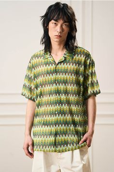 This shirt brings a retro coolness with a casual edge, echoing the rhythmic waves of summer. The Geometric Ripple Knitted Half Shirt in Watermelon is a canvas of continuity, where V-shaped ripples merge into a pattern reminiscent of a watermelon's intricate rind. The Cuban collar contributes a dash of old-school charm, fitting for any relaxed setting or as a statement piece for the more adventurous. Its breathable knit ensures a comfortable experience, making it an ideal choice for warm-weather Vacation Geometric Pattern Short Sleeve Tops, Vacation Tops With Geometric Pattern And Short Sleeves, Short Sleeve Tops With Geometric Pattern For Vacation, Vacation Short Sleeve Top With Geometric Pattern, Casual Geometric Pattern Tops For Vacation, Beach Tops With Geometric Pattern And Short Sleeves, Summer Cotton Tops With Geometric Pattern, Casual Collared Tops With Geometric Pattern, Casual Collared Top With Geometric Pattern