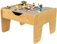 a child's wooden table with legos on top and one drawer in the middle