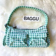 New With Tag. Color: Green Gingham A Baguette Style Purse With Two External Flap Pockets For Easy Access To Your Essentials. - Two Exterior Flap Pockets With Magnetic Closure - Measures 4.7" H 11" W 3" D - Adjustable 29.5" Quilted Strap - Recycled Heavyweight Nylon With Recycled Ripstop Lining - Machine Washable ** First Time On Poshmark? Use Code Emmmamercer When You Create Your Poshmark Account To Receive A $10 Credit Toward Your First Purchase. ** Trendy Tote Shoulder Bag For Picnic, Trendy Rectangular Shoulder Bag For Picnic, Trendy Rectangular Bag For Picnic, Trendy Rectangular Bags For Picnic, Trendy Rectangular Bag For Picnics, Trendy Rectangular Picnic Bag, Casual Gingham Shoulder Bag For Picnic, Casual Gingham Shoulder Bag For Summer, Rectangular Plaid Shoulder Bag For Picnic