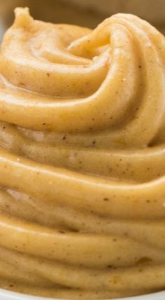 a white bowl filled with peanut butter on top of a table