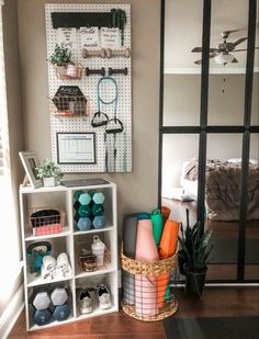 a room filled with lots of different items on shelves next to a mirror and potted plants