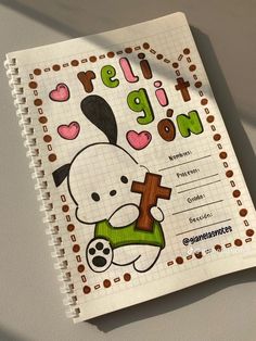 a spiral notebook with an image of a bunny holding a cross on it's cover