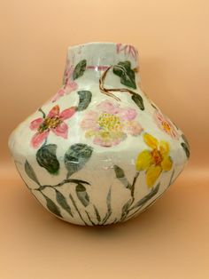 a white vase with flowers painted on it