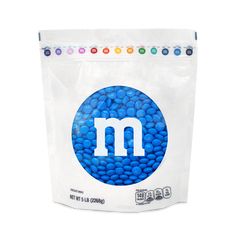 a bag of m & m's with blue beans in it on a white background