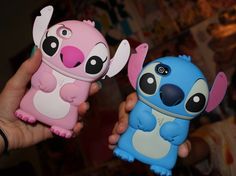 two cell phones in the shape of animals being held by someone's hands,