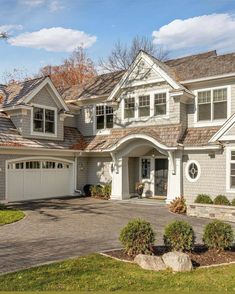 a large house with two car garages in the driveway