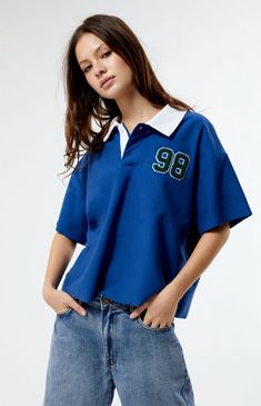 PacSun's Oversized Rugby T-Shirt brings a touch of preppy charm to the scene. Featuring a classic collared neckline, button closures, short sleeves, left chest patches, and the perfect relaxed fit, it's the epitome of laid-back style. Score some easygoing vibes with this must-have tee.   	Collared neckline 	Short sleeves 	Button closures 	Relaxed oversized fit 	Left chest patch detail 	Machine washable 	Model is wearing size small 	Model measurements: 5’7” height, 32.5” bust, 25.5” waist, 36” hip Pacsun T Shirts, Rugby Shirt Aesthetic, Short Sleeve Button Up Shirt Outfit, Oversized Polo Shirt Outfit Women's, Oversized Polo Outfit, Blue Tshirt Outfit, Nba Style, Oversize Tshirt Outfits, Polo Shirt Outfits