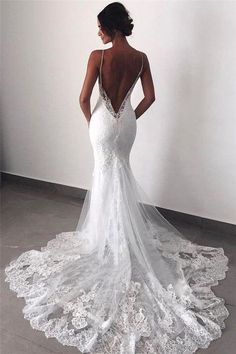 a woman in a white wedding dress looking back