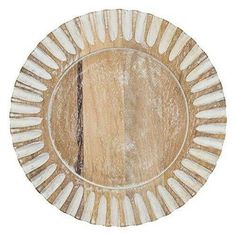 a wooden plate with white and brown designs on it