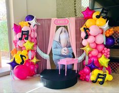 a table topped with balloons and musical instruments