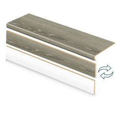 the side profile of a white and gray wood skirting board with an arrow pointing up