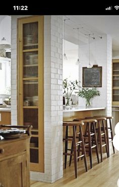 the kitchen is clean and ready to be used for dinner or breakfast time, as well as bar stools