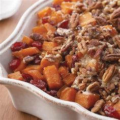 a casserole dish filled with sweet potatoes and pecans