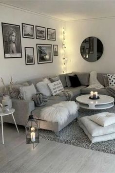 a living room filled with lots of furniture and pictures on the wall above it's coffee table