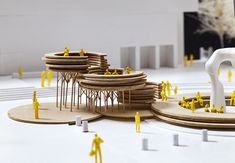 a group of wooden structures with yellow figures around them