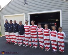 a group of people dressed in red and white striped pajamas standing next to each other