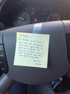 a note attached to the steering wheel of a car