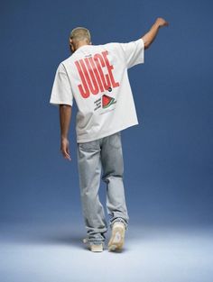 a man in white shirt and jeans pointing at something