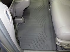 the interior of a car with grey floor mats