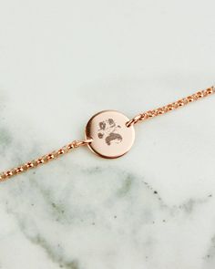 a gold bracelet with a baby's handprint on it