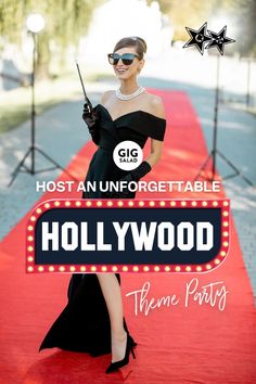 a woman in a black dress holding a radio on a red carpet with the hollywood sign behind her