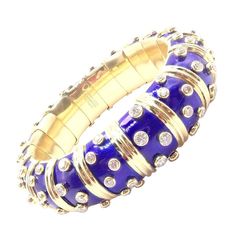 About This Piece: The Tiffany & Co Schlumberger Dots Bangle Bracelet features 18k yellow gold adorned with round brilliant diamonds and vibrant blue enamel. Designed by Jean Schlumberger, it combines elegance with playful sophistication,... Jean Schlumberger, Chanel Ring, Hermes Jewelry, French Jewelry, International Jewelry, Enamel Bangle, Diamond Gold, Hinged Bangle, Brilliant Diamond