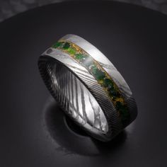 "The ring is crafted from a piece of jewelry grade stainless steel damascus and the inlay is accented with 24k gold before being packed with pieces of bright green natural emerald gemstone and real meteorite! Crafted personally by hand in Hawaii, each ring is made to order with customization options available. Reach out to me with any questions or ideas, and I'll work with you to design the perfect ring. Thank you for supporting my small business!\" Resizing policy: Please note that these rings Men’s Emerald Engagement Rings, Luxury Inlay Rings For Anniversary, Luxury Green Engraved Men's Ring, Luxury Unique Green Men's Ring, White Gold Titanium Jewelry With Polished Finish, Elegant Titanium Jewelry With Polished Finish, Formal Titanium Ring Jewelry, Elegant Green Inlay Rings, Luxury Handmade Men's Emerald Ring