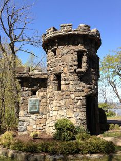 an old stone tower sitting in the middle of a forest