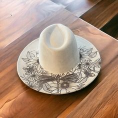 a white hat sitting on top of a wooden table