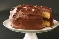 a cake with chocolate frosting on a white plate