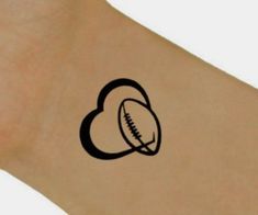 a heart shaped tattoo with a football on it