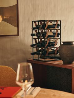 a wine rack sitting on top of a wooden table