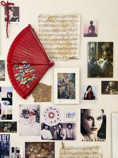 a white refrigerator covered in pictures and red fan next to it's magnets