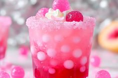 a close up of a drink in a glass with ice and fruit on the rim