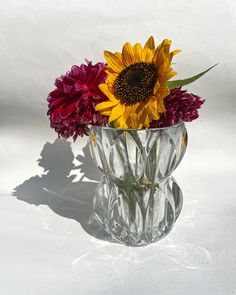 a vase filled with flowers on top of a white table