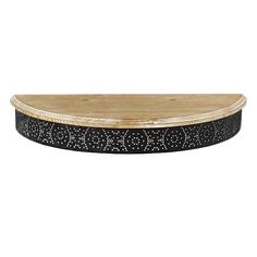 an oval wooden tray with black and white speckles on the bottom, against a white background