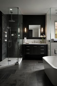 a bathroom with a large tub, sink and shower stall in it's center