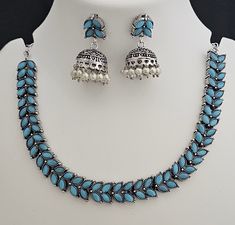 Oxidized Silver blue stone Leaves design Necklace with matching cute Jhumki - MK Fashionkart - Fashion Jewelry Material:  Oxidized Silver and Blue stone Earrings: Beautiful matching Jhumka Suitable for Saree/Salwar/party wear dresses Adjustable length  SHIPPING : Ready to ship in 1 business day. This item will be shipped from The United States. Jewelry care instructions : 1. Please wipe the jewelry with a piece of cotton cloth after usage.  2. Store the jewelry in a cool, dry and air tight box or pouch.  3. Make sure the jewelry is away from direct heat and water. 4. Please wipe of any moisture, sweat, soap water after usage. Blue Bollywood Jewelry Sets For Gift, Blue Bollywood Style Jewelry Sets For Gift, Blue Bollywood Jewelry Sets With Stone Work, Blue Festive Jewelry Sets For Diwali, Bollywood Blue Stone Work Jewelry Sets, Festive Blue Jewelry Sets With Stone Work, Traditional Blue Jewelry Sets, Handmade Bollywood Blue Jewelry, Blue Stone Work Necklace For Festive Occasions