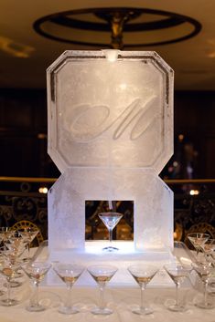 an ice sculpture with martini glasses on it