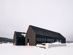 the building is covered in snow and has two windows