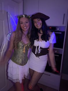 two women dressed in costumes posing for the camera