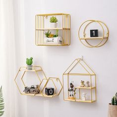 three metal shelves with plants and toys on them, one is hanging from the wall