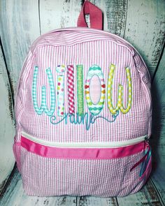 "Precious personalized Backpack or bookbag. Perfect for school, sports, dance, overnight, or a diaper bag I can get matching lunchboxes! Just send me a message 🎒Regular sized backpacks (15\"x 12\"x4\") come with 2 cup holders, adjustable straps, outside zippered pocket and a mesh pocket inside. Colors: Navy, Red, Pink, Purple, Aqua & grey 🎒Toddler sized backpacks (12\"x 9.5\" x 4\") have 2 outside mesh pockets, adjustable straps, outside zippered pocket and a mesh pocket inside. Colors: na Monogram Applique, Personalized Backpack Kids, Embroidered Backpack, Orange Backpacks, Pink Seersucker, Unique Handbags, Red Backpack, Personalized Backpack, Minimalist Bag