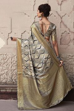 A playful colored saree with lots of drama. This saree is the element of style you have been looking for. With a splendid border, this is a sure-shot choice. This saree is a suitable amalgamation of style and grace that is required from an ethnic wear. The saree is ideal for any formal gathering. The saree comes with an unstitched blouse of corresponding color and design as shown in the picture. Fabric Type : Handloom SilkColor: GreyLength: 6.3 meters (including 85 cms blouse fabric) Blouse Fabr Grey Silk Saree, Women's Traditional & Ceremonial Clothing, Trendy Saree, Handloom Silk Saree, Indo Western Gown, Saree Petticoat, Saree Jewellery, Silk Weaving, Lehenga Skirt