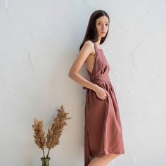 🌿 Step into a world of effortless beauty and undeniable charm with our Cross Back Apron Dress! 🌿 Crafted from the finest linen, this versatile and stylish piece is a must-have addition to your wardrobe. 💃 The exquisite cross back design adds a touch of elegance to this sleeveless dress, making it a perfect choice for any occasion. Whether you're attending a summer wedding, going on a brunch date, or simply strolling through the city streets, this dress will make you feel confident and radiant. 👜 Practicality meets style with the addition of convenient pockets, perfect for carrying your essentials on the go. From your phone to your favorite lipstick, you'll have everything you need at your fingertips. 🌞 Embrace the carefree spirit of summer with our Linen Sundress. The breathable fabri Linen Pinafore Dress, Linen Apron Dress, Cross Back Dress, Linen Pinafore, Cross Back Apron, Linen Sundress, Dress Cottagecore, Dress Linen, Apron Dress