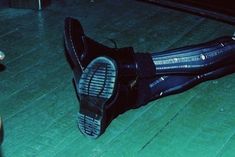 a pair of black shoes sitting on top of a wooden floor